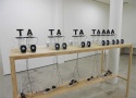 Humberto Duque - "AAAAT-AT-AT-AT", exposed discs spinning on portable cd players with text characters, 2014